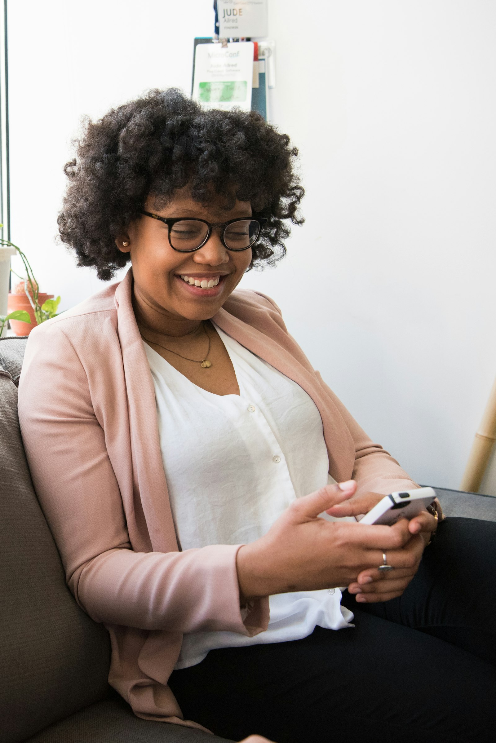 Woman smiling at her phone on social media