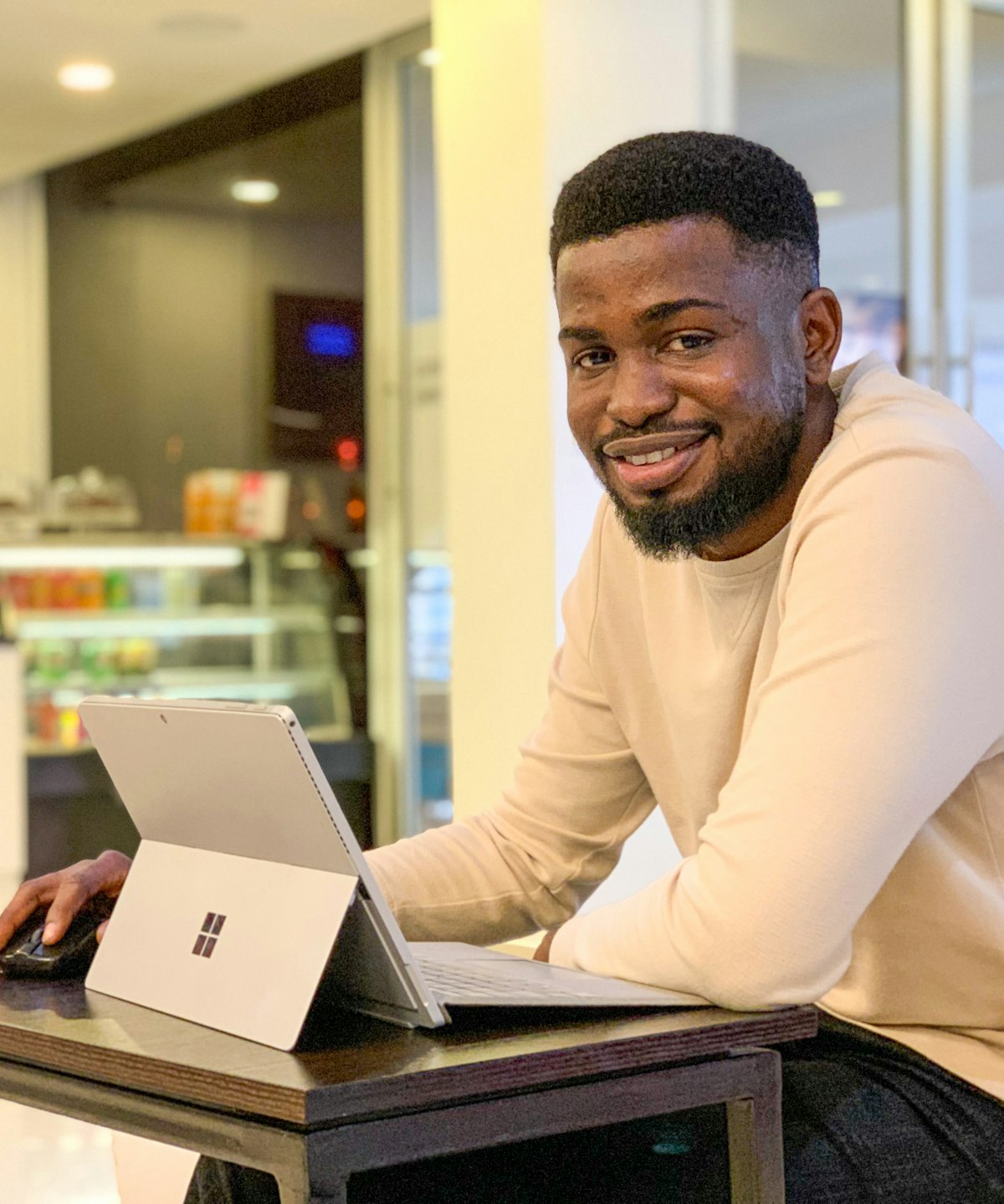 Smiling developer working on a tablet laptop