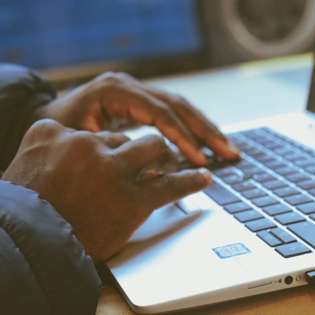 Developer typing code on a laptop